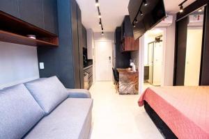 a bedroom with a bed and a couch in a room at Studio de Luxo de Alta Qualidade in Sao Paulo