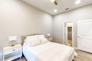 a white bedroom with a bed and a dresser at Uvalde Avenue Abode in McAllen