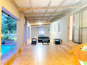 a living room with a pool in a house at Listos Guest House in Empangeni