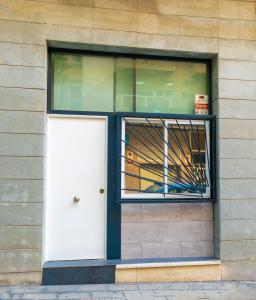 a white door in a window of a building at Estudio en el pleno centro de Alicante by Renthas in Alicante