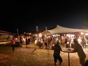 a crowd of people standing around a tent at night at Blues Camping BeaverCreek Grolloo in Grolloo