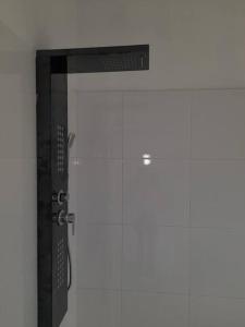 a shower stall with a glass door in a bathroom at Stay Jamaica Villa 
