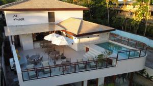 an aerial view of a house with a swimming pool at AL MAR SUÍTES in Praia do Forte