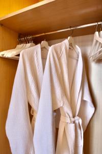 two white towels are hanging on a rack at Belvedere 229 Lakeview Apartment in Ghiffa