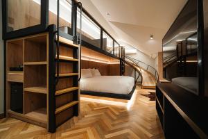 a room with a bunk bed and a staircase at Bavaria Sport Hotel in Gramado