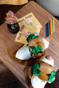two stuffed teddy bears are sitting on a table at Bavaria Sport Hotel in Gramado