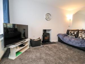 a living room with a flat screen tv and a couch at 3 Thrimby Court in Morecambe