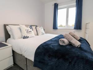 a bedroom with a bed with towels on it at 3 Thrimby Court in Morecambe