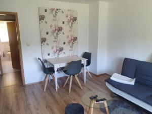 a living room with a table and chairs and a couch at Monteurwohnung Kuhfelde in Kuhfelde