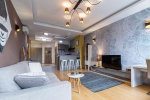 a living room with a couch and a tv at Midtown Artistic Apartment in Budapest