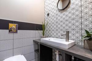 a bathroom with a sink and a toilet at Midtown Artistic Apartment in Budapest +11 photos