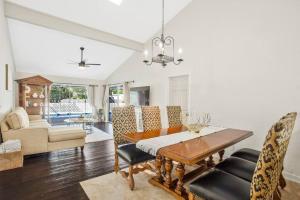 a living room with a dining table and chairs at Naples Oasis in Naples