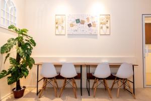 a table with four chairs and a map on the wall at Momostay in George Town