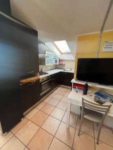 a kitchen with a table and a chair in it at Above The Sky - Flying Apartment in San Marino