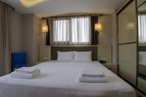 Postel nebo postele na pokoji v ubytování Funda Hotel