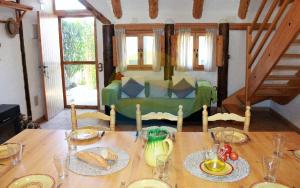 einen Tisch mit Brot und eine grüne Couch in einem Zimmer in der Unterkunft Barraca típica del Delta, con piscina, jardín y barbacoa - Deltavacaciones in Sant Jaume d’Enveja