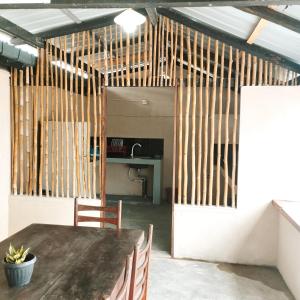 a dining room with a table and wooden walls at Glance Beach Ahangama in Ahangama