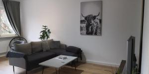 a living room with a couch and a bull on the wall at Im Herzen von Hauenstein in Hauenstein
