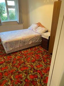 a bedroom with a bed and a rug at Country House 20 minutes to Galway City in Kilcolgan