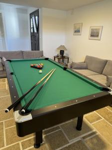 a living room with a pool table and a couch at BlueGreen Villa in Karteros
