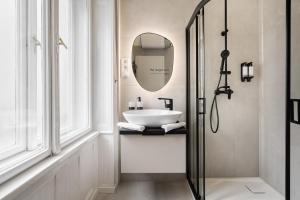 un baño con lavabo y espejo en You Boutique Suites, Best Location by BQA, en Budapest