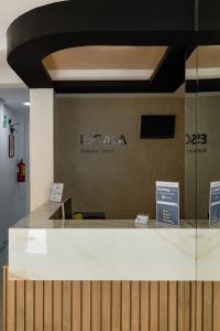 a reception desk with a sign on a wall at ESCALA BUSINESS HOTEL in Chiclayo