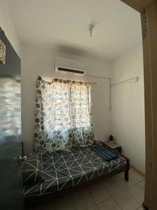 a bed in a room with a window at Gayang Tuaran in Tuaran