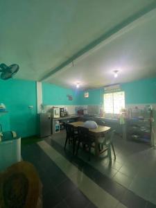 a kitchen with a table and chairs in a room at Gayang Tuaran in Tuaran