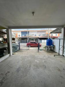 a garage with a red car in a parking lot at Gayang Tuaran in Tuaran