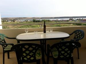 a table with wine glasses and a bottle of wine at Apartmani Manuela Ljubač in Ljubač
