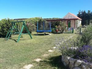 a yard with a swing set and a house at Apartmani Manuela Ljubač in Ljubač