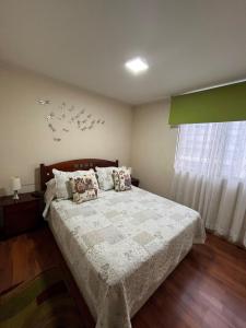 a bedroom with a bed with birds on the wall at Playa Brava - Iquique in Iquique