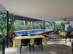 a table and chairs with a boat on a patio at Balai Benedicere Bed & Breakfast in Bacnotan