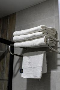 a group of white towels on a towel rack in a bathroom at BRANDROOM HOTEL in Istanbul