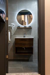 a bathroom with a sink and a mirror at BRANDROOM HOTEL in Istanbul
