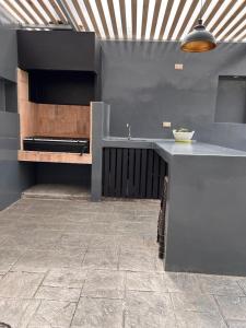 a kitchen with a counter and a sink in a room at Gran Casa confortable en Santiago in Lampa