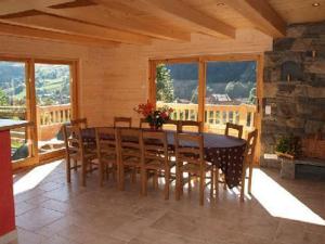 a wooden dining room with a table and chairs at Chalet Le Grand-Bornand, 6 pièces, 12 personnes - FR-1-467-44 in Le Grand-Bornand