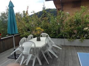 a table and chairs on a patio with an umbrella at Appartement Le Grand-Bornand, 4 pièces, 8 personnes - FR-1-467-53 in Le Grand-Bornand