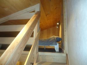 a staircase leading up to a bedroom in a wooden house at Appartement Le Grand-Bornand, 2 pièces, 5 personnes - FR-1-467-26 in Le Grand-Bornand