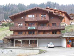 a large wooden building with a balcony on it at Appartement Le Grand-Bornand, 2 pièces, 5 personnes - FR-1-467-26 in Le Grand-Bornand
