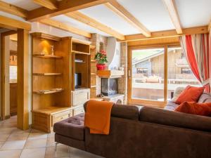 a living room with a couch and a fireplace at Appartement Le Grand-Bornand, 3 pièces, 9 personnes - FR-1-467-98 in Le Grand-Bornand