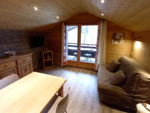a living room with a couch and a table at Appartement Le Grand-Bornand, 2 pièces, 4 personnes - FR-1-467-113 in Le Grand-Bornand
