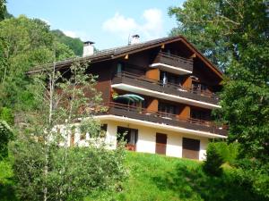 a house on top of a hill with trees at Appartement Le Grand-Bornand, 2 pièces, 4 personnes - FR-1-467-113 in Le Grand-Bornand
