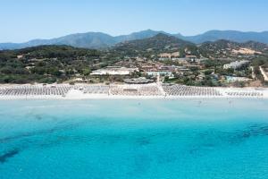 an aerial view of a beach with turquoise water at VOI Tanka Village in Villasimius