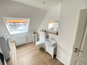 a white bathroom with a sink and a mirror at Dagmar 120qm 3 Schlafzimmer Wellness in Olsberg