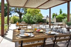 a wooden table with plates of food on it at Quinta d'Anta- Hotel Rural in Maiorca