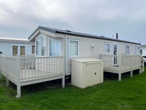a mobile home with two decks on the grass at Heron, Sea View, Scratby - California Cliffs, Parkdean, sleeps 6, bed linen and towels included, pet free, onsite entertainment available in Scratby