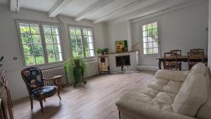 a living room with a couch and a fireplace at LES VOLETS BLEUS in Metz