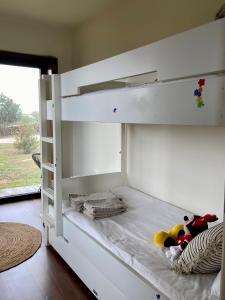 a white bunk bed with some stuffed animals on it at Quinta Alto da Fraga in Vila Nova de Foz Coa