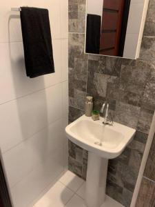 a white bathroom with a sink and a shower at Acogedora casa en Cobija in Tres Puentres